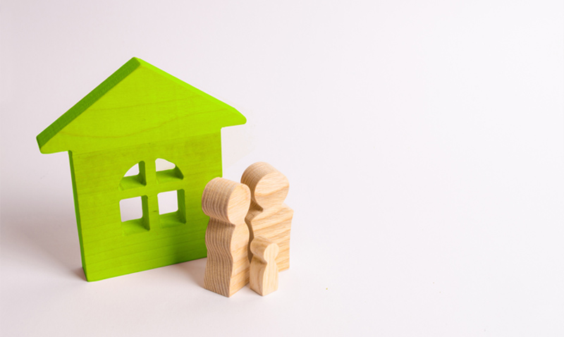 Wooden house and family. Buying a new home. State program of assistance to young families. Subsidy. Rental housing, Mortgage and loans. Quiet and comfortable home in the suburbs. investment.
